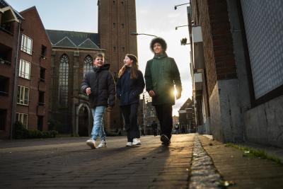 Drie jongeren die door de stad lopen 